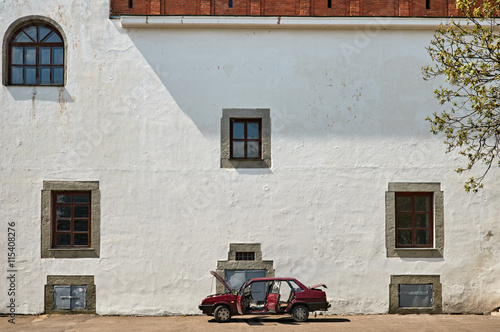 Old castle wall with car in Dubno, Ukraine photo