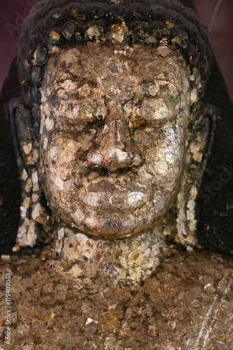 close up Buddha statue gilded in the measure