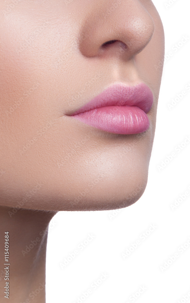 Close-up of woman's lips with bright fashion pink glossy makeup. Macro magenta lipgloss make-up. Sexy pink lip makeup. Highly saturated color. Lipstick