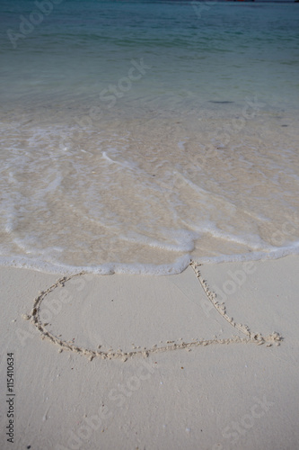 hearts drawn on the sand of a beach