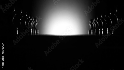 Chessboard and chess pieces in dark room