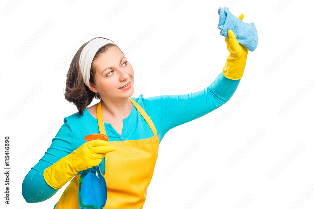 Young housewife cleans something on a white background Young housewife cleans something on a white background
