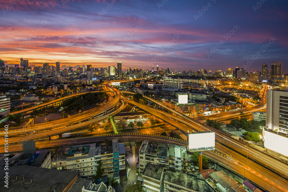 Fototapeta premium The traffic jam on expressways of Bangkok city with colorful sky twilight, tilt-shift blur effect