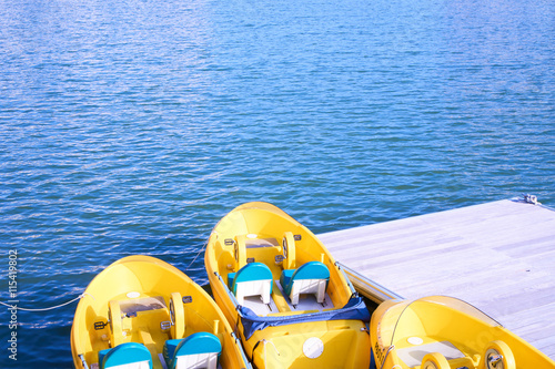 Yellow water bicycles and clear blue water