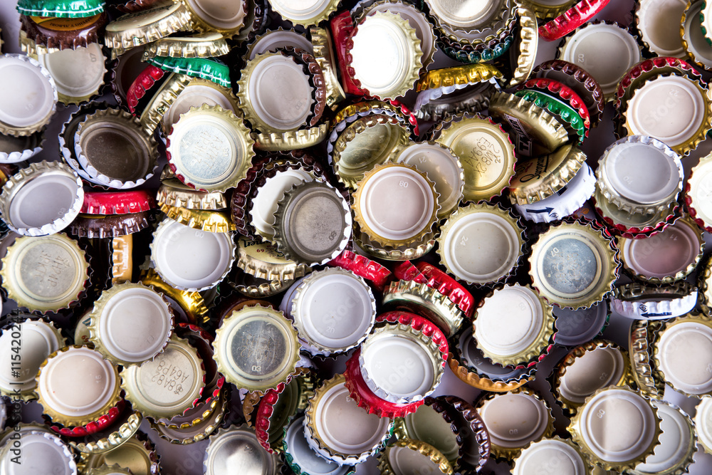 a lot of caps of beer, top view a lot of caps of beer, top view
