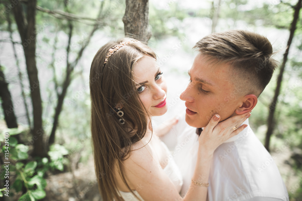 Wedding couple man, bride kissing and hugging on a background of the river, mountains. Beauty portrait Wedding couple man, bride kissing and hugging on a background of the river, mountains. Beauty portrait