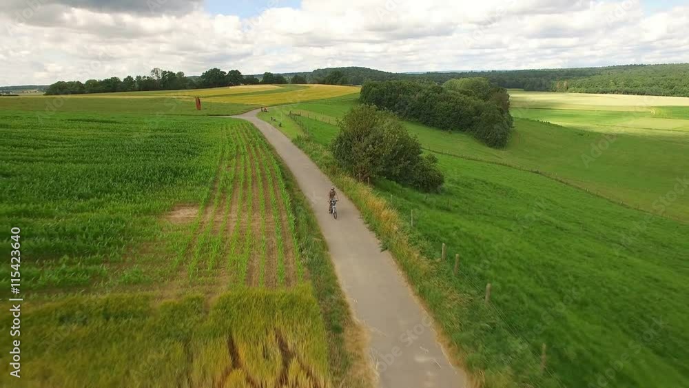 Aerial view of senior man riding his mountain bike Aerial view of senior man riding his mountain bike
