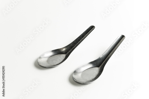 Fotografi used two asian silver table spoons on white background