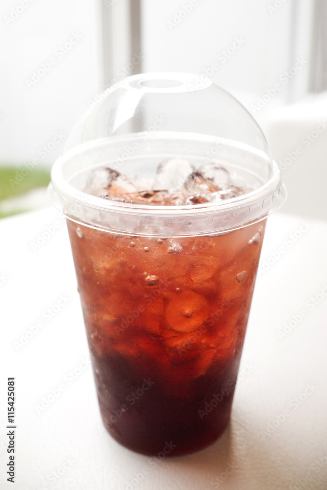 Fresh ice tea in plastic glass with straw Fresh ice tea in plastic glass with straw