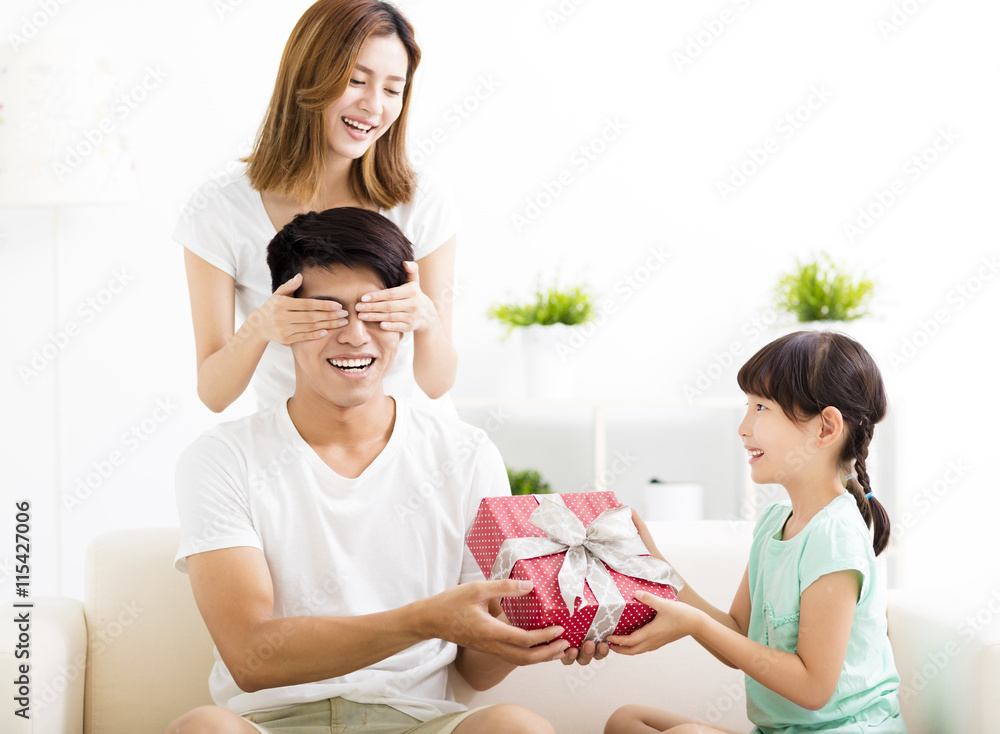 surprised Father receiving gift box from wife and daughter surprised Father receiving gift box from wife and daughter