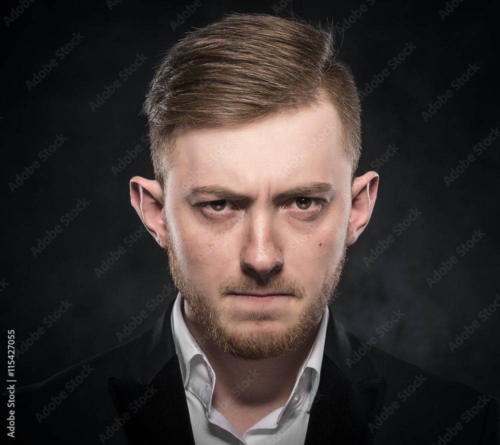 Elegant young man in suit looking frowning. Elegant young man in suit looking frowning.