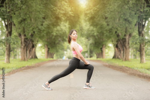 Young woman practicing yoga and exercise outdoor in park.