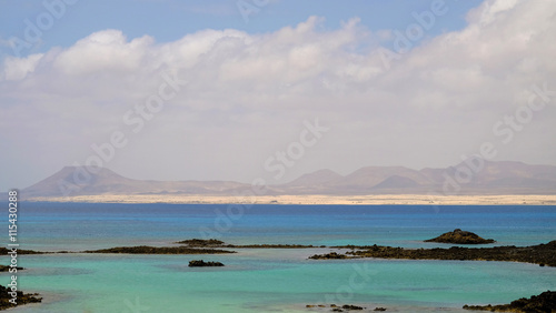 The lagoon on the island Lobos and the dunes in Corrolejo on the background.
