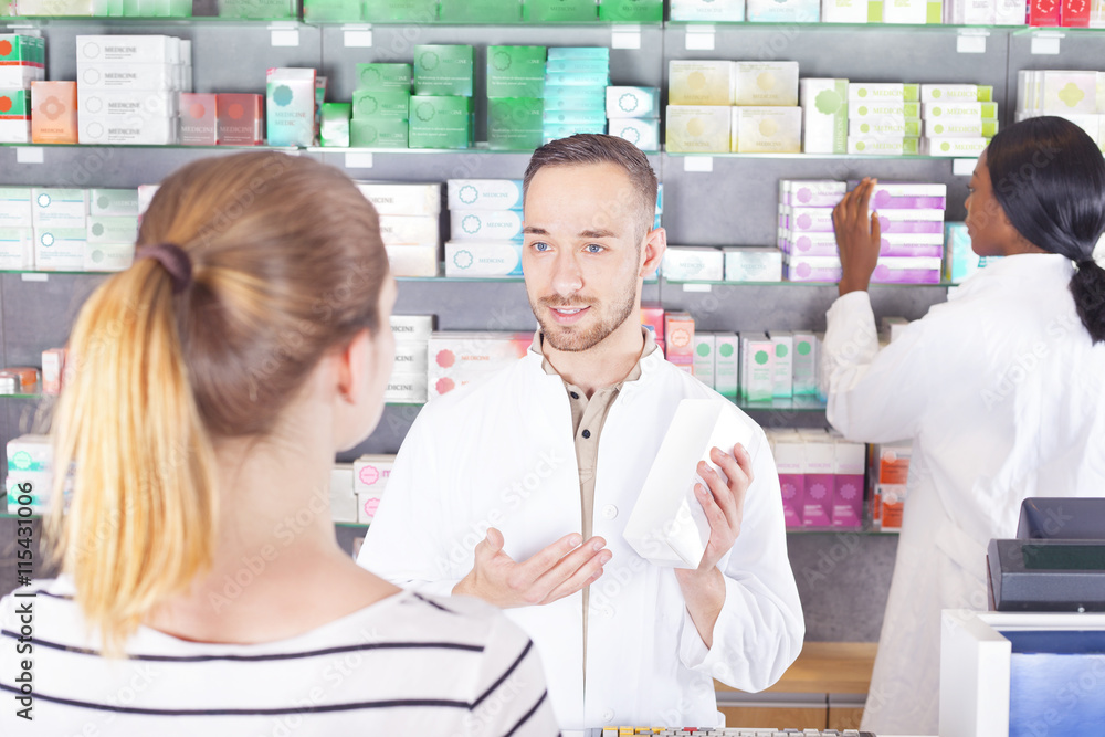 Pharmacist attending customer