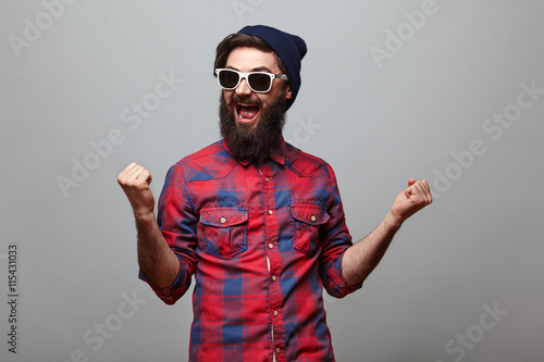 happy hipster man with beard exults photo