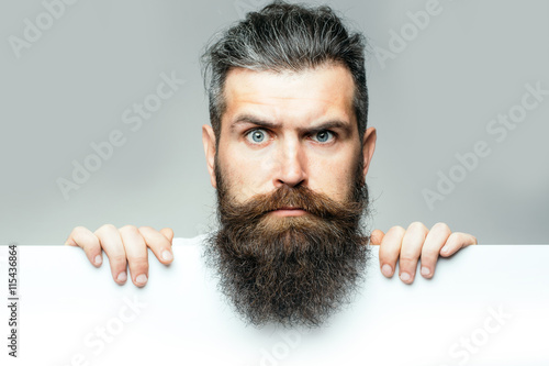 bearded surprised man with paper Fototapeta