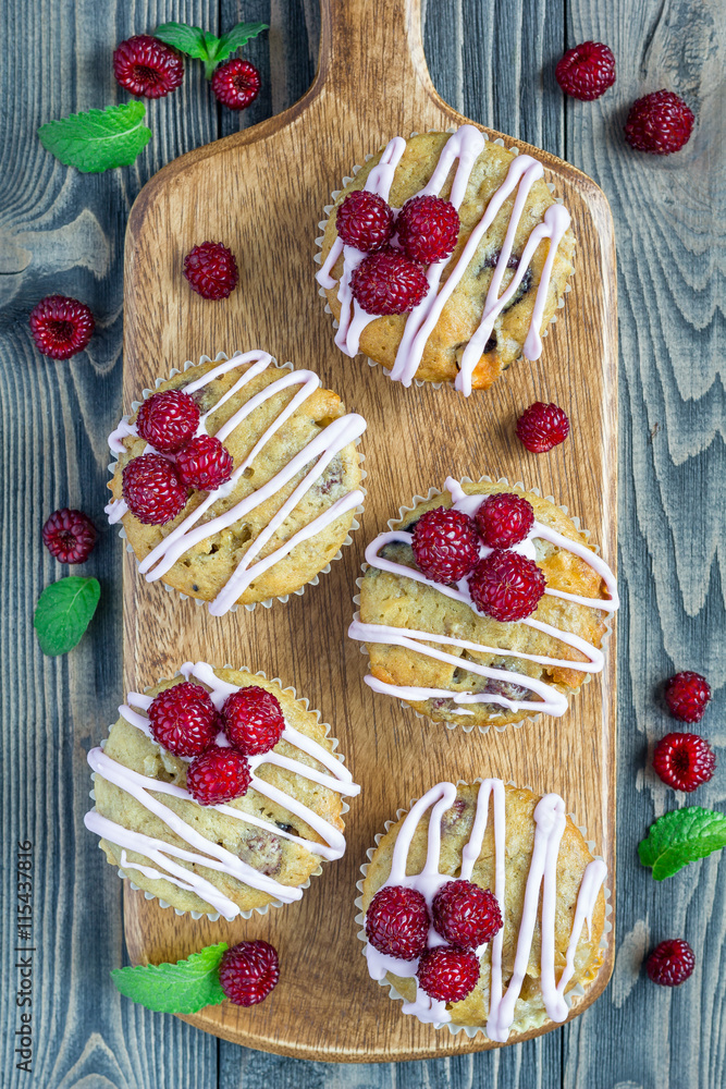 Banana bread muffins with raspberries, cherries, white chocolate, top view