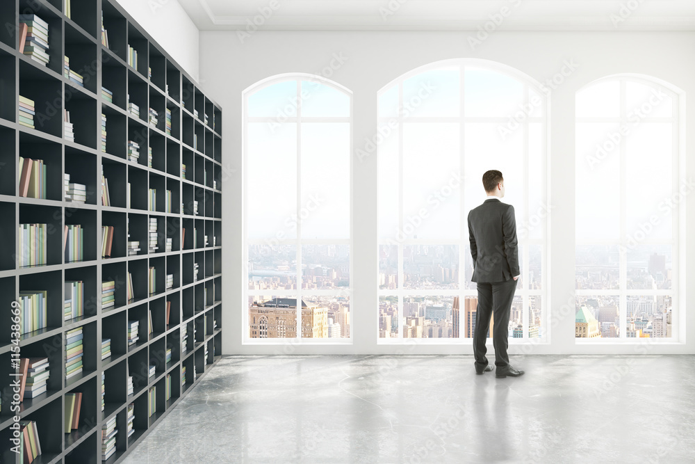 Thoughtful businessman in library side Thoughtful businessman in library side