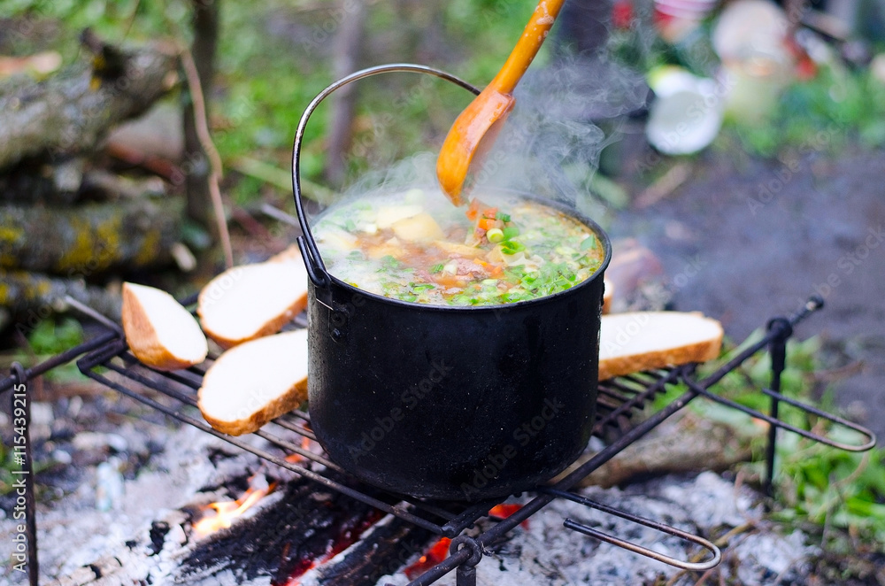 The cooking of soup on the fire The cooking of soup on the fire
