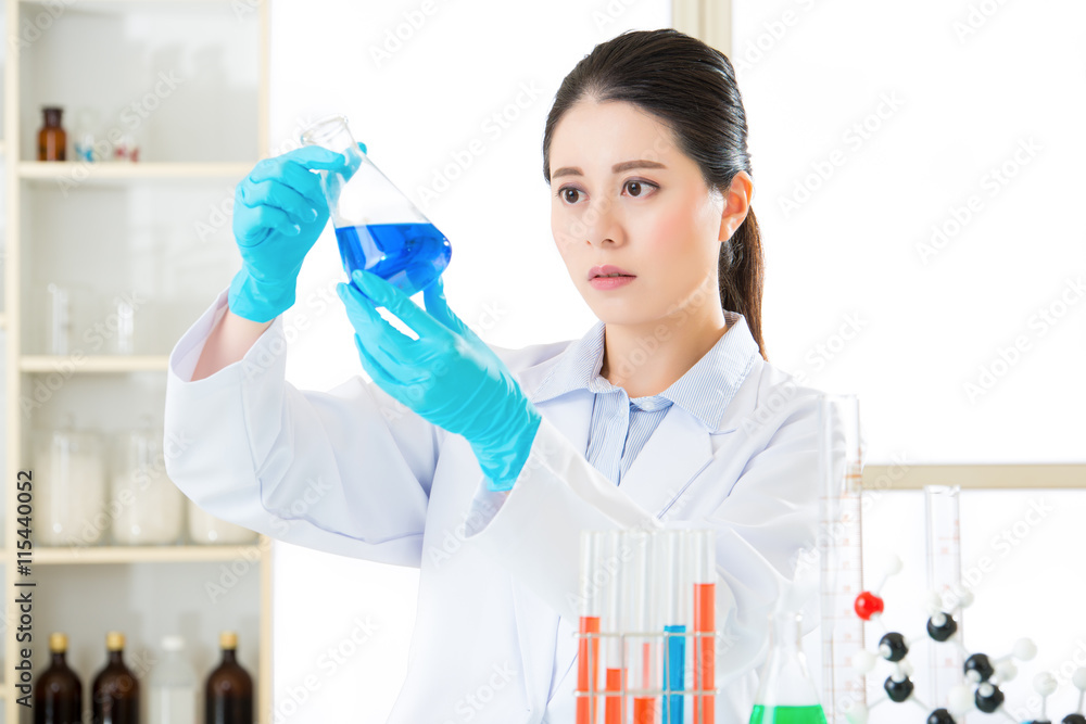 Asian female scientist know the answers are all in the details Asian female scientist know the answers are all in the details