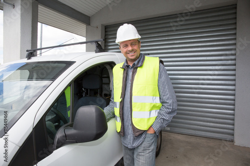 Engineer builder man at construction site close to his car photo