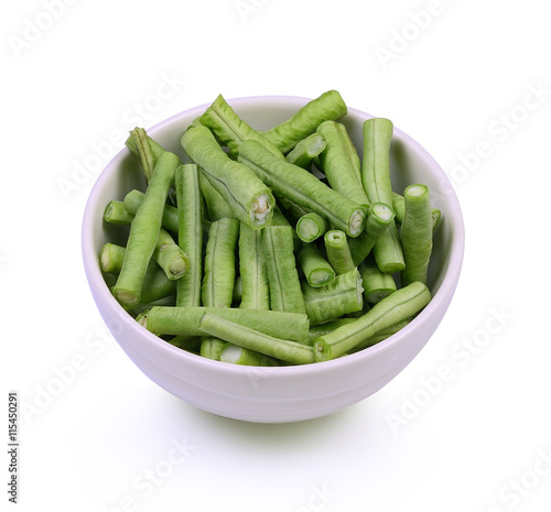 Slices yardlong bean in white bowl isolated on white background.