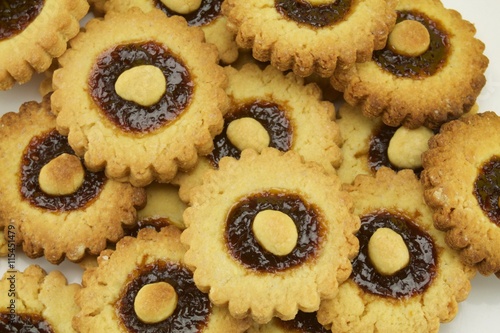 close up of butter cokies with plum jam photo