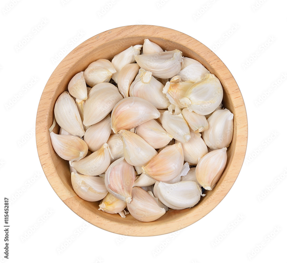 Top view Garlic cloves in wood bowl on white background Top view Garlic cloves in wood bowl on white background