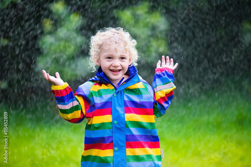 Little boy playing in the rain