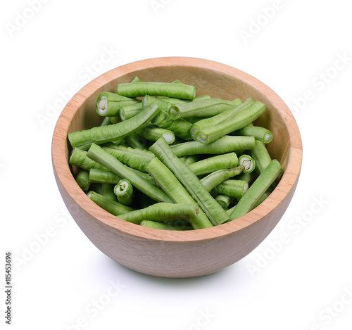 Slices yardlong bean in wood bowl isolated on white background.