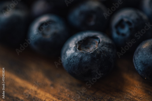 Blueberry pile on wooden table, macro