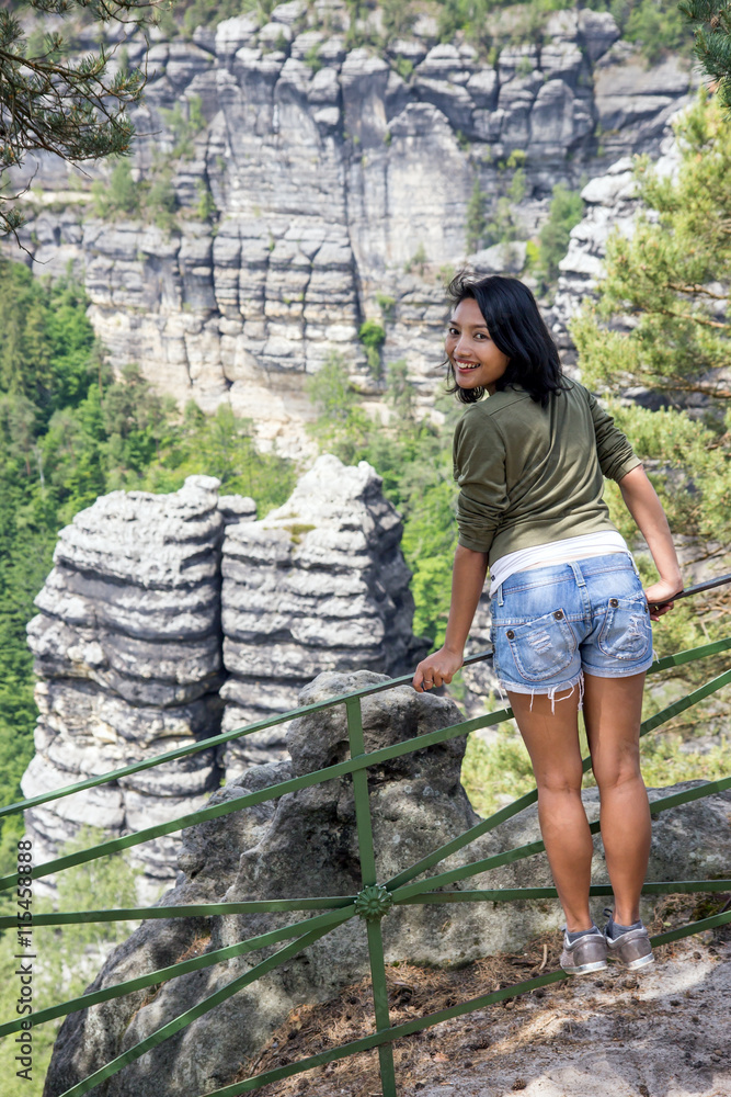 Naklejka premium Woman on the lookout in nature, Bohemian Switzerland