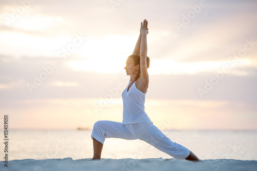 Foto Caucasian woman practicing yoga at seashore