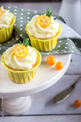 Cupcakes with cream cheese on white support.