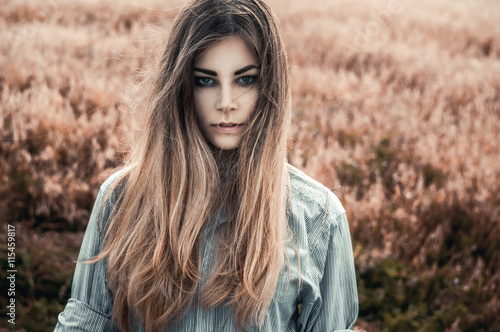 Beautiful and young girl in a man's shirt standing in the field.  shirt for the girl. Nature. Wind inflates hair. © Steve Kline