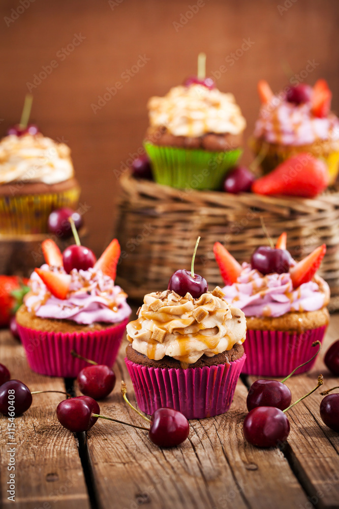 Delicious cupcakes decorated with caramel and fresh berries Delicious cupcakes decorated with caramel and fresh berries