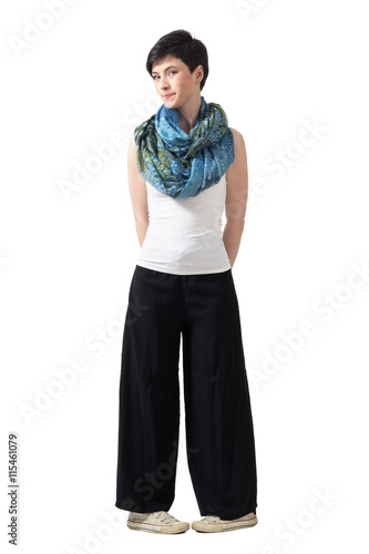 фотографія Shy bashful young short hair woman in wide pants in awkward leg pose