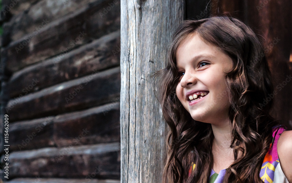 Fototapeta premium little girl sitting on the porch of the house