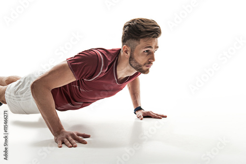 Strong man doing push-ups with concentration