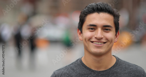 Young latino man in city face portrait smile photo