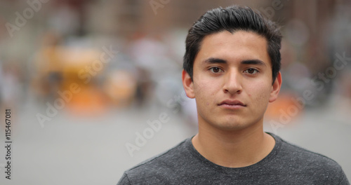 Young latino man in city face portrait serious