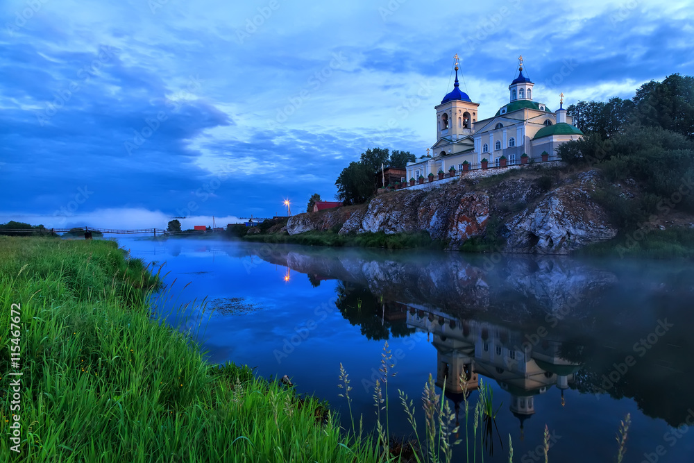 Fototapeta premium Russian orthodox church. Fog over river near the cliff and church. Ural, Chusovaya.