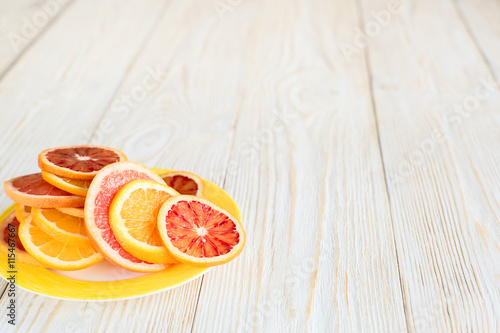 Citrus fruits on wood table background with copy space.