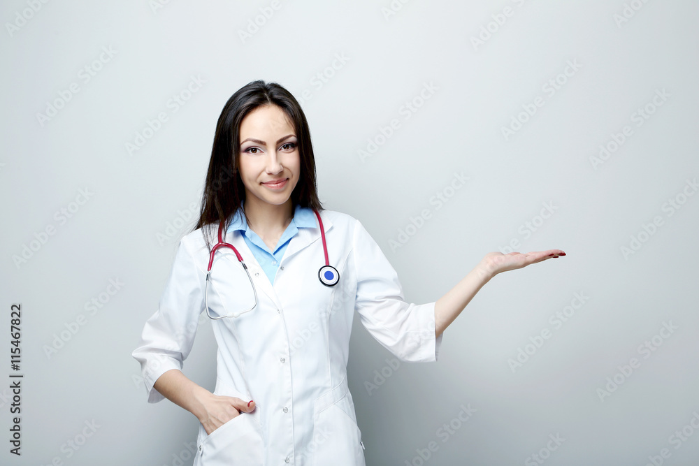 Portrait of young medical doctor on a grey background Portrait of young medical doctor on a grey background