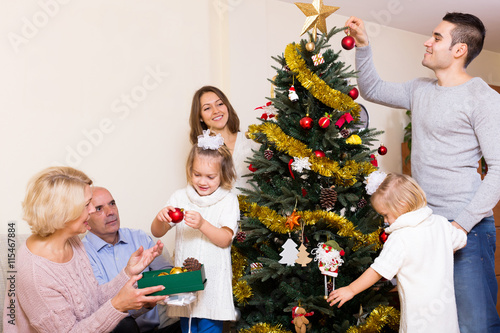 family with decorated Christmas tree