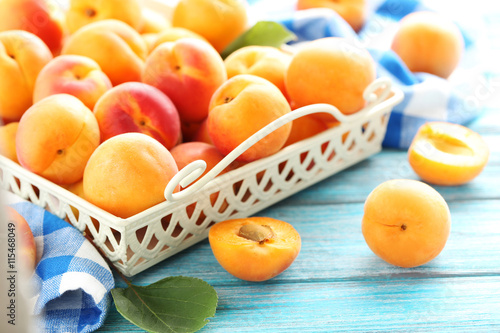 Ripe apricots fruit on blue wooden table