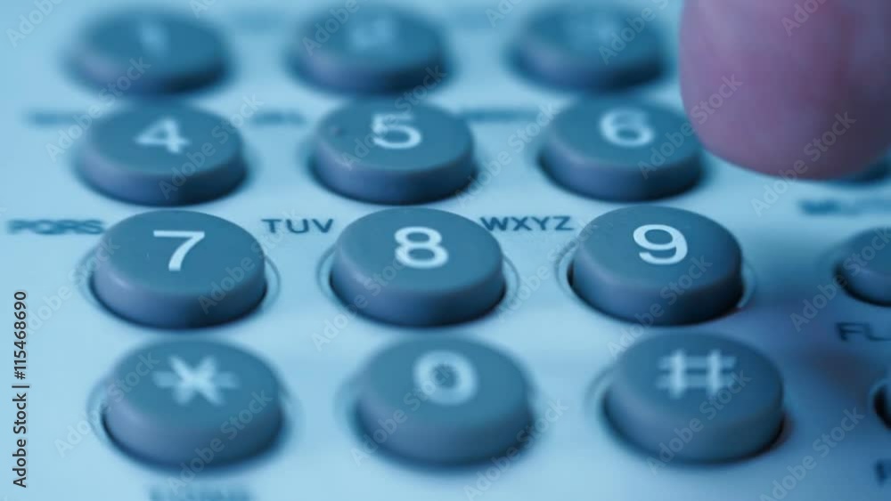 Hand picks up the white (black) phone, dials a number and hangs up. Closeup