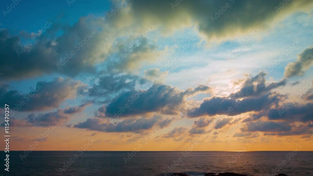 Puffy clouds build and drift across a colorful and darkening sky as sunset approaches over a seascape horizon, in timelapse. UltraHD video Puffy clouds build and drift across a colorful and darkening sky as sunset approaches over a seascape horizon, in timelapse. UltraHD video