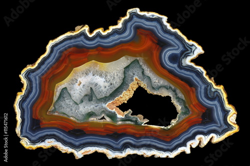 A cross section of the agate stone with geode on a black background. Origin: Brazil. photo