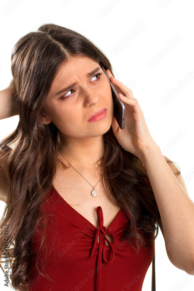 Obraz premium Upset woman holds a phone. Red keyhole dress and necklace. My mood is spoiled. Things are worse than ever.